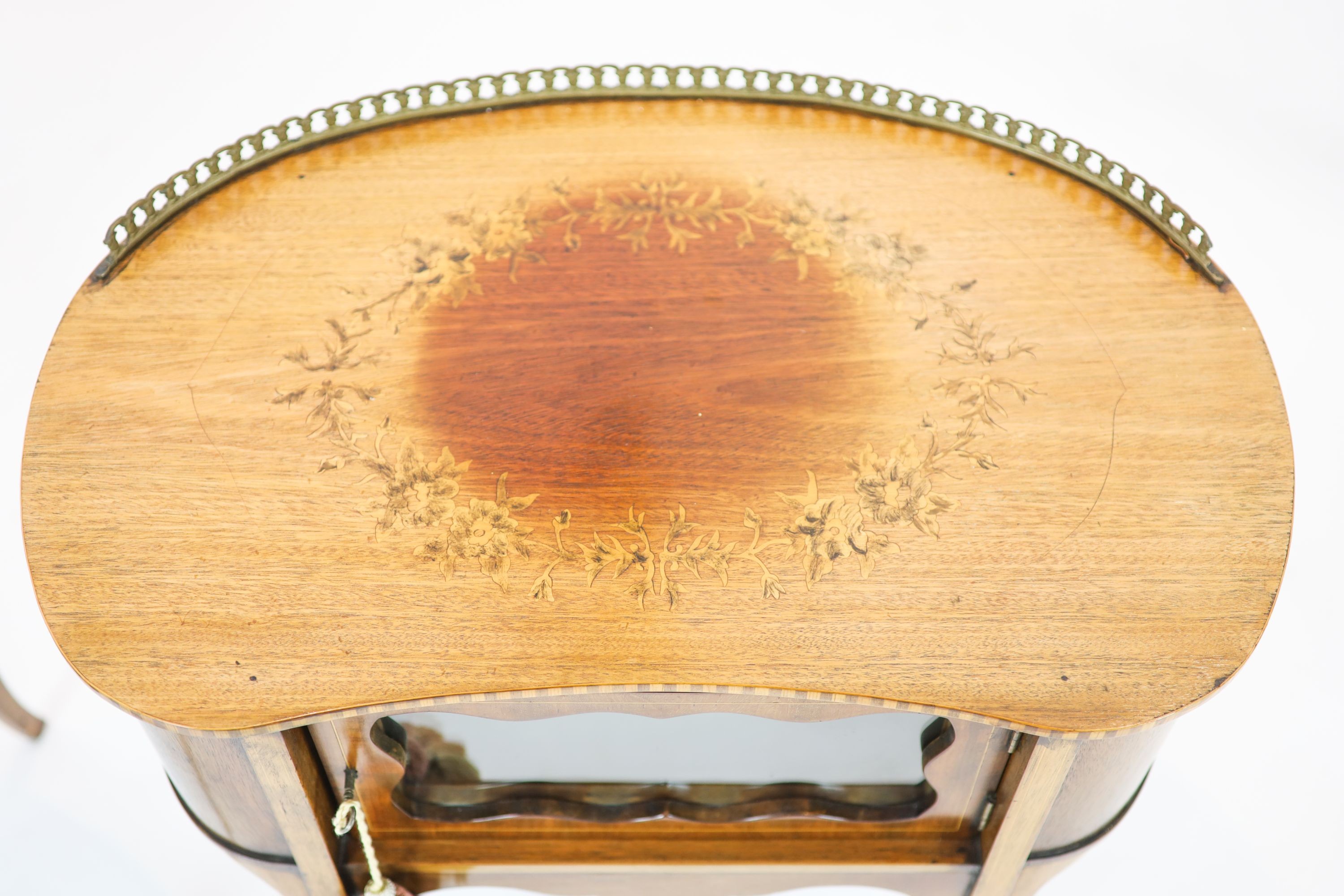 A pair of Edwardian inlaid mahogany kidney shaped side cabinets, each fitted with a central glazed door, raised on cabriole legs, width 60cm, depth 37cm, height 70cm